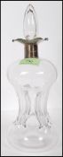 An early 20th Century clear glass klux klux hourglass decanter having an English hallmarked four way