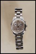 A contemporary ladies Michael Kors wrist watch having a round face with a silvered dial with baton
