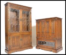An Old Charm carved oak lead glaze Linen Fold  bookcase over cupboard base with linen fold