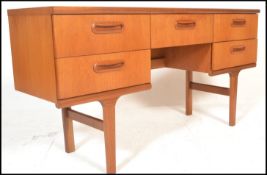 A retro teak wood 20th Century desk / dressing table constructed with a series of drawers with