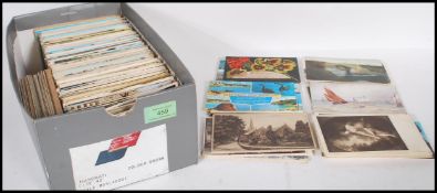 A shoebox full of various mixed postcards dating from the early 20th Century to include church