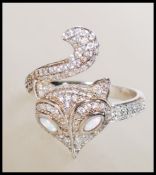 A stamped 925 silver ladies dress ring in the form cat having opal eyes with cz accent stone