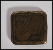 A vintage 1940's Chinese brass cigarette case of square engraved with decorative panels to the front