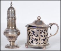 A silver hallmarked Arthur Cook & co pepperette having a bulbous body raised on a round footed