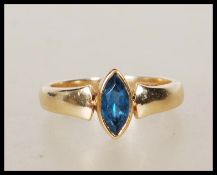 A 9ct gold English hallmarked ring bezel set with a marquise cut blue stone. Assay marked for