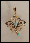 A stamped 9ct yellow gold Art Nouveau style pendant necklace of open wirework form set with