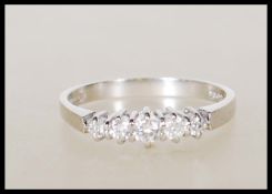 A hallmarked 18ct white gold ladies dress ring set with five graduating diamonds of approx 25