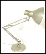A vintage retro 20th Century 1001 Lamps anglepoise lamp raised on a circular base with conical