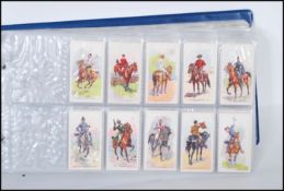 A collection of trade cards and giveaway cards to include two sets of Riders of The World issued