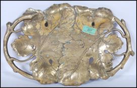 A 20th Century Art Nouveau style gilt brass twin handled dish / tray, the handles modelled as vine