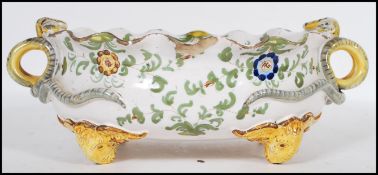 An 19th Century Italian faience centerpiece dish having a fanned rim with curled serpent twin