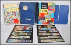 A collection of world stamps over four stamp albums, the stamps dating to the 20th Century, stamps