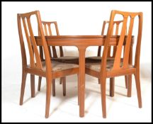 A retro 20th Century teak wood extendable dining table and matching chairs by Nathan, the circular