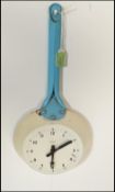 A retro mid 20th Century 1950's metal wall clock by Paico in the form of a frying pan having blue