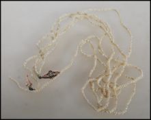 A three string Victorian pearl necklace having a decorative 9ct yellow gold clasp with central