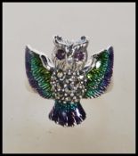 A stamped 925 silver ladies dress ring in the form of a owl having enamel plique a jour wings and