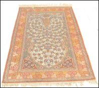 An early 20th Century persian style floor rug carpet, large central ornate panel surrounded by