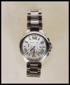 A contemporary Michael Kors chronograph wrist watch having a round white enamelled face with roman