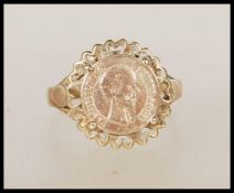 A hallmarked 9ct gold ring set with a 1865 Mexican gold coin. Hallmarked London. Weight 2.3g. Size