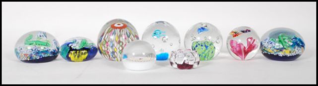 A collection of eight 20th Century glass studio paperweights to include an example by Murano