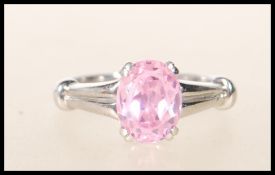 A stamped 9k 375 white gold single stone dress ring having central faceted prong set pink stone with