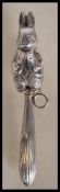 A silver baby's rattle in the form of Peter Rabbit having a hollow carved body with loop fitting