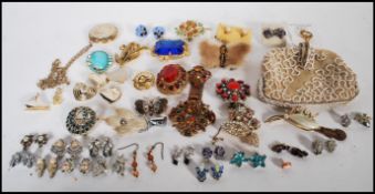 A collection of vintage 20th Century costume jewellery brooches to include a Scottish Grouse foot