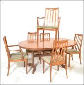 A G plan teak D end extending dining table with fold out central leaf over a plain frieze and