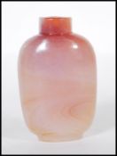 A late 19th / early 20th Century Chinese carved pink agate snuff bottle of tapering form, missing