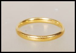 A hallmarked 22ct gold wedding band ring. Hallmarked Birmingham (date marks rubbed). Weight 2.6g.