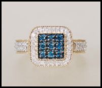 A hallmarked 9ct gold dress ring having a square head set with a square cluster of blue stones