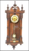 A 20th Century spring driven eight day wall hanging Vienna regulator, the walnut case surmounted