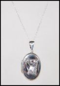 A stamped 925 silver necklace pendant locket having and embossed image of a horse with ruby eyes