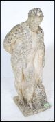 A 20th Century well weathered reconstituted stone garden statue figure of Hercules, leaning