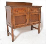 An early 20th Century Edwardian oak sideboard / credenza, gallery back with flared top over two