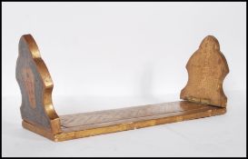 A late 19th / early 20th Century metamorphic gilt wood bookend having a central patterned centre