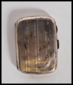 An Art Deco silver hallmarked cigarette case of rectangular bowed form with engine turned stripe