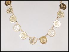 A 9ct yellow gold Chinese necklace having a total of eleven tokens modeled as Chinese coins and
