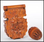A 20th Century carved coquilla nut pomander case being carved with concentric circle patterning with