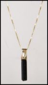 A stamped 750 18ct gold fine box link necklace chain having a black crystal pendant. Weight 3.5g.