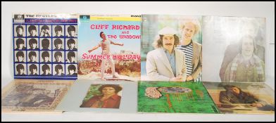 A collection of vinyl long play LP vinyl record albums from various artists to include The Beatles A