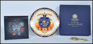 A collection of items to include a Royal Mint Commemorative plate by Royal Worcester commemorating