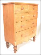 A 19th century Victorian scrubbed pine two short over two long chest of drawers, turned handles