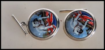 A pair of stamped 925 silver cufflinks having central enamelled panel decoration depicting a British