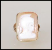 A hallmarked 9ct gold ring set with a carved rectangular cameo to the head depicting a roman