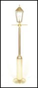 A retro 20th Century upright floor standard lamp in the style of a Victorian street lamp having a