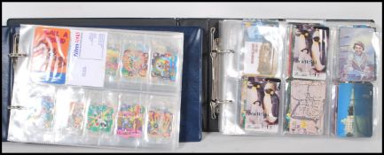 An album containing a collection of retro telephone cards from around the world together with a