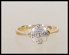A stamped 9ct gold and platinum Art Deco 1930's ring having a geometric patterned platinum headset