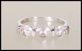 A hallmarked 9ct white gold ring set with three oval cut pink stones. Hallmarks for Birmingham