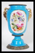 A 19th Century French ceramic urn vase in the manner of Sevres having a powder blue ground with